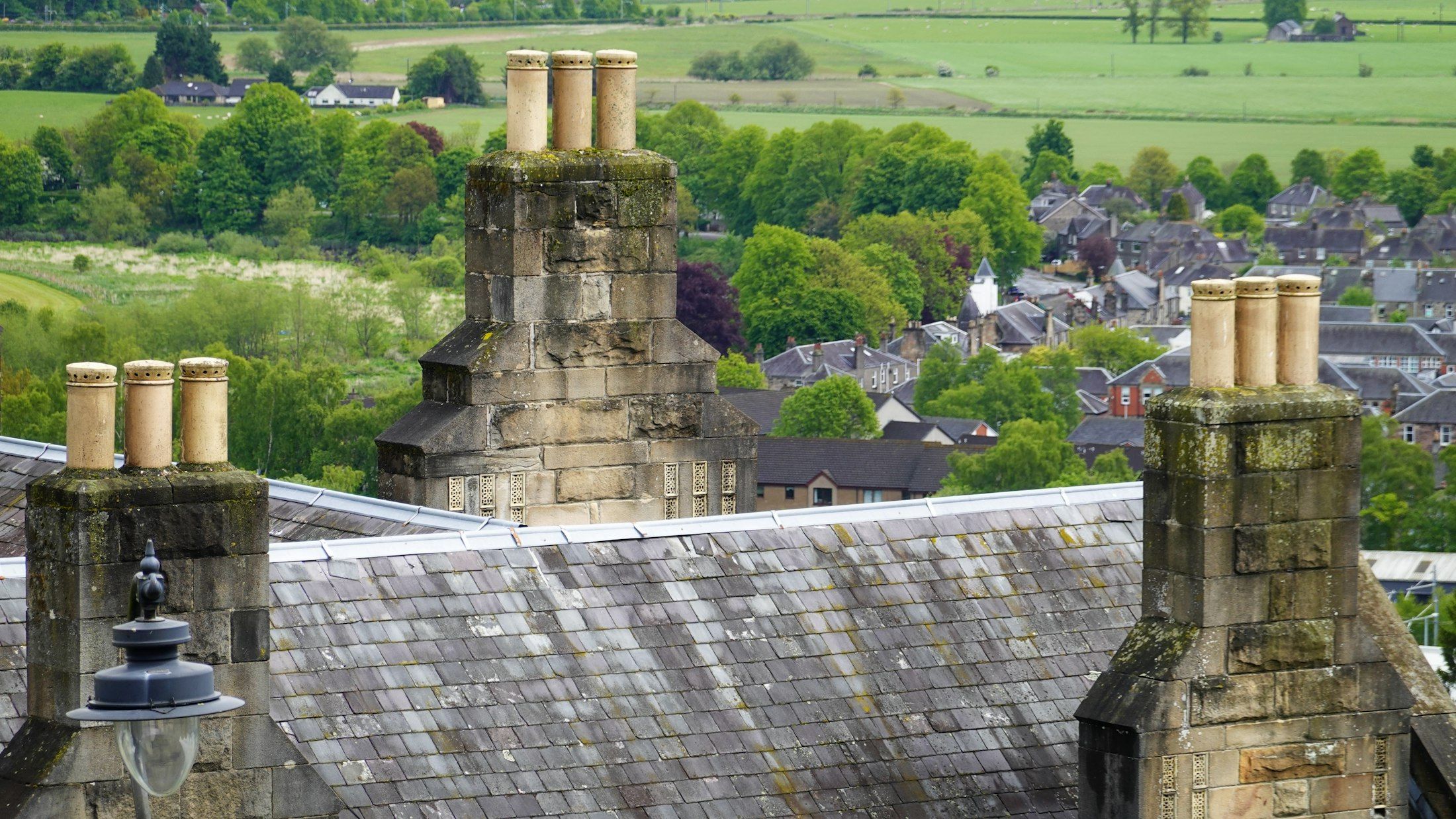 Stone chimneys on a slate roof with lead flashing A. Dawson Roofing Services Fife