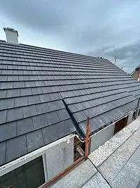Grey concrete roof tiles and ridge on a house roof A. Dawson Roofing Services Kirkcaldy