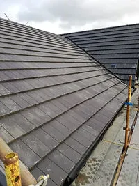 Roof tiles laid along the eaves with scaffolding A. Dawson Roofing Services Fife