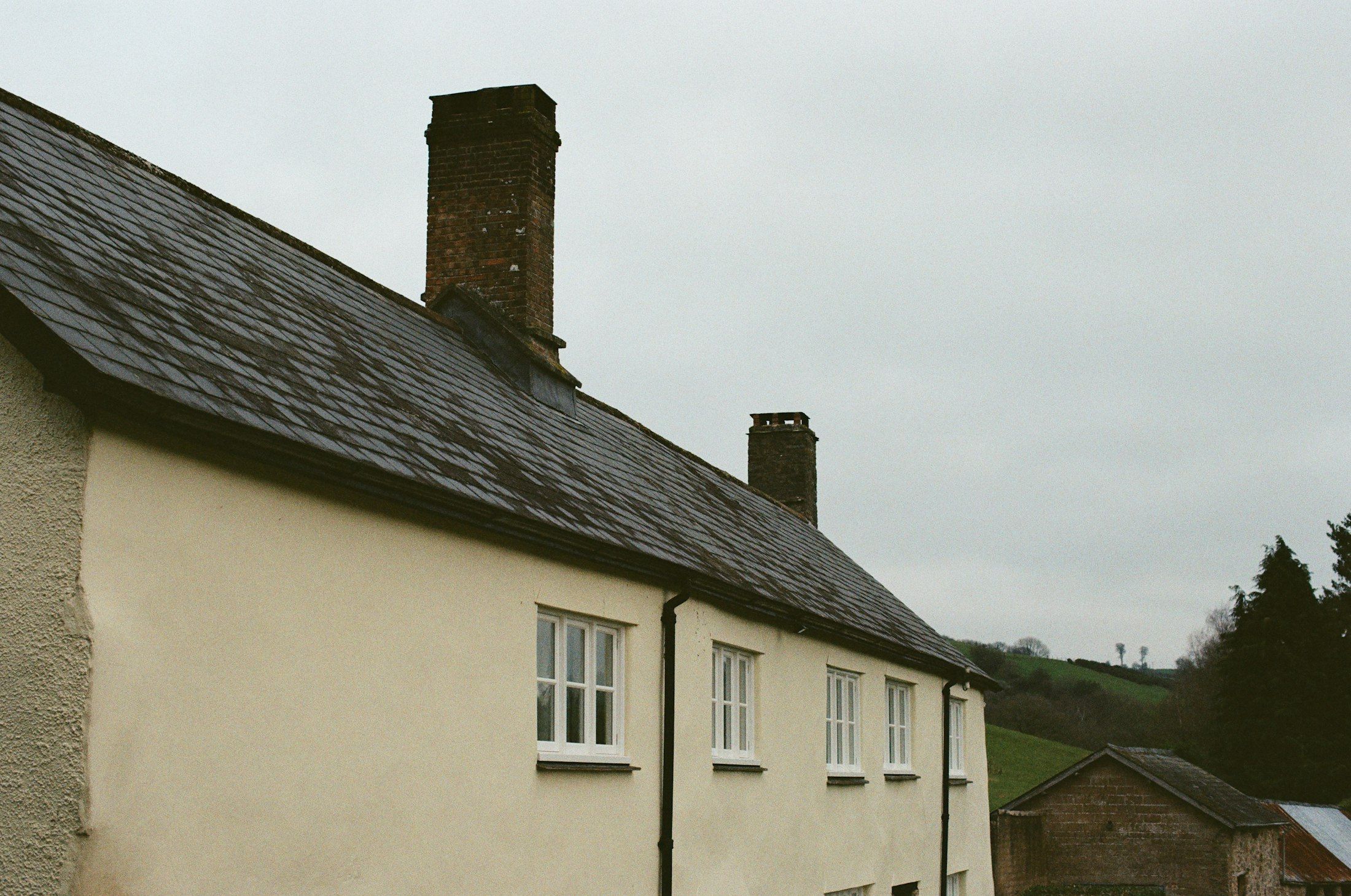 Rendered cottage with slate roof and chimneys A. Dawson Roofing Services Fife
